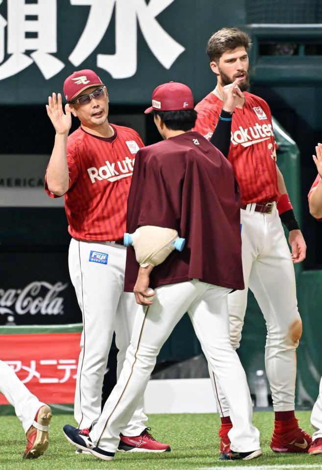 早川（手前）とタッチを交わす楽天・吉井監督（左奥）とマッカスカー