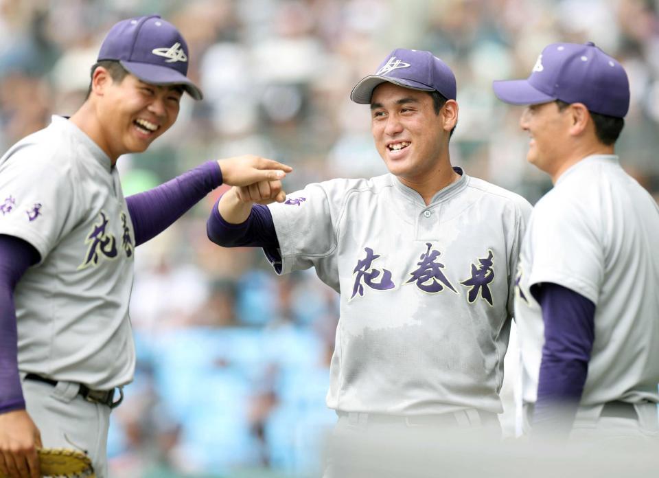 　３回、ピンチを切り抜け、古城（左）とタッチを交わす花巻東・赤間。右は佐々木監督（撮影・中田匡峻）