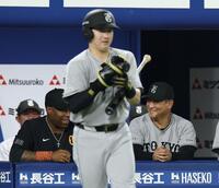 ９回、泉口（手前）のプロテクターを修理したウィーラーコーチ（左）に笑みを見せる橋上監督代行（撮影・伊藤笙子）