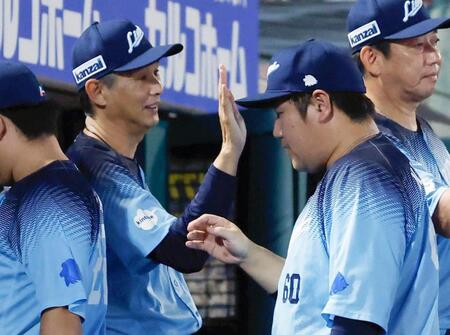 楽天に勝利し、中村剛（手前右）らを迎える西口監督（左）