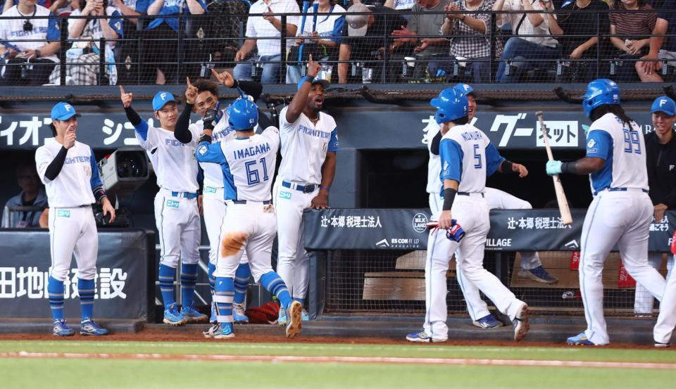 ５回、逆転３ランを放った今川（６１）らを迎える日本ハムナイン（撮影・中島達哉）