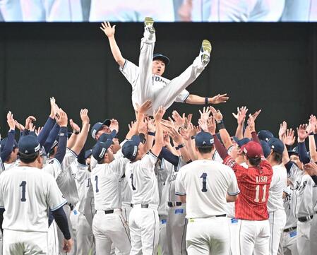 チームメイトと岸に胴上げされる栗山（撮影・持木克友）