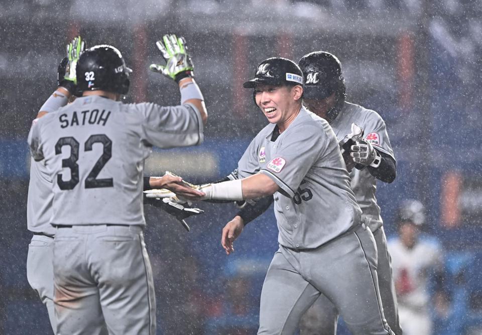 ７回、勝ち越しの左越え満塁弾を放ちナインとタッチを交わす寺地（右手前）＝撮影・開出牧