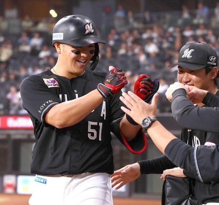　９回、勝ち越しソロを放ち、ナインにとタッチを交わす山口（撮影・中島達哉）