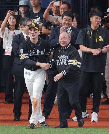 栗原（左）に連れられて胴上げの輪に向かう孫正義オーナー（撮影・立川洋一郎）