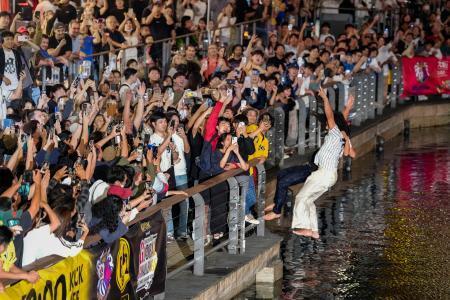　阪神タイガースがセ・リーグ連覇を決め、大阪・ミナミの道頓堀川に飛び込む人たち＝３日夜