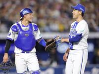 ５回、無失点に抑え、松尾（左）とタッチを交わす平良（撮影・西岡正）
