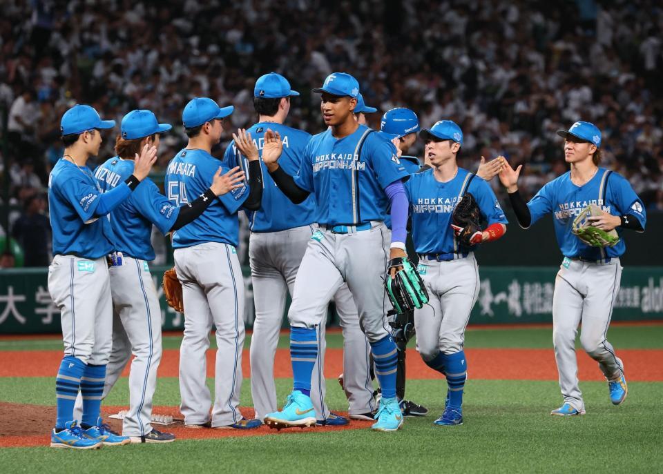 西武に勝利をあげ、タッチを交わす日本ハムナイン（撮影・中島達哉）