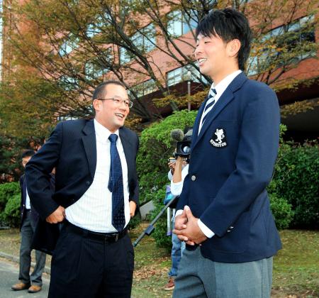 　田村スカウト（左）と談笑する九州共立大学・大瀬良（撮影・出月俊成）