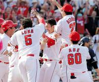 ９回、鈴木誠也（中央）は、左越えに２試合連続となる逆転サヨナラ３ランアーチを放ち、仲間から祝福される＝マツダスタジアム（撮影・吉澤敬太）