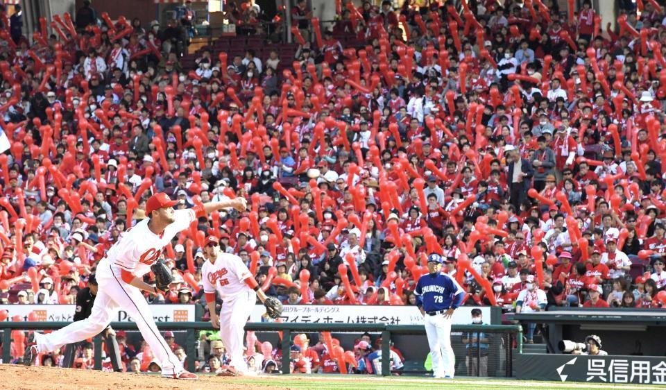 　ジェット風船で真っ赤に染まるスタンドを背に力投するジョンソン（撮影・飯室逸平）