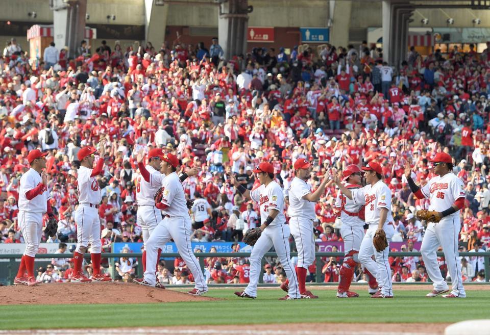 巨人に連勝し勝利のハイタッチを交わす広島ナイン＝マツダスタジアム（撮影・飯室逸平）