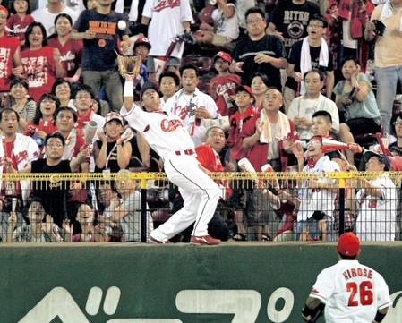 　横浜・ハーパーの本塁打性の打球をフェンスに登り捕球する天谷＝２０１０年８月２２日