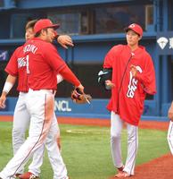 逆転負けを喫し、広島・鈴木誠也（左）らナインをベンチ前で迎える広島・森下暢仁（右）＝横浜スタジアム（撮影・高石航平）