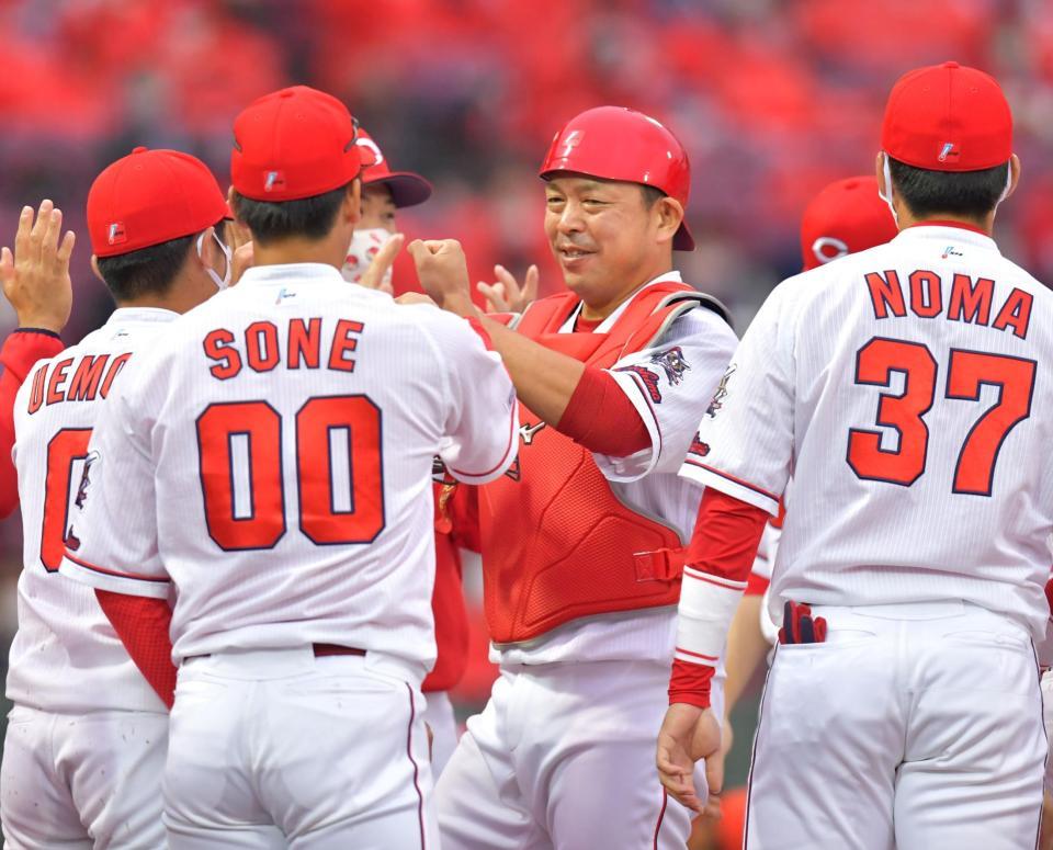 ８回表の守備に就き、無失点で終えてナインに迎えられる捕手・広島・石原慶幸（中央）＝マツダスタジアム（撮影・立川洋一郎）