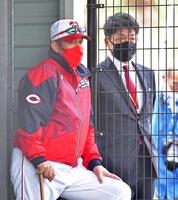 佐々岡監督（左）と並んでブルペンで投げ込む投手陣を見守る石原慶幸氏（撮影・立川洋一郎）