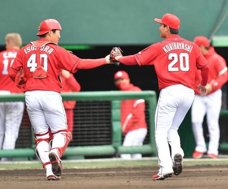 ６回に登板、無失点に抑えて磯村嘉孝（左）とタッチを交わす広島・栗林良吏＝沖縄セルラースタジアム那覇（撮影・西岡正）