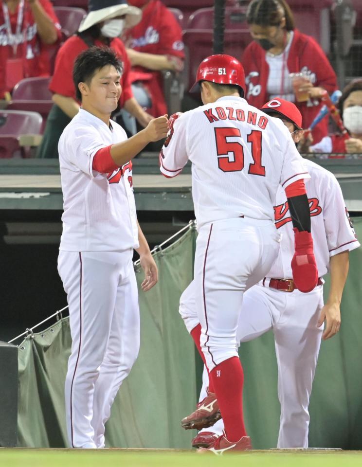 　３回、西川の中犠飛で生還した小園を出迎える床田（撮影・立川洋一郎）