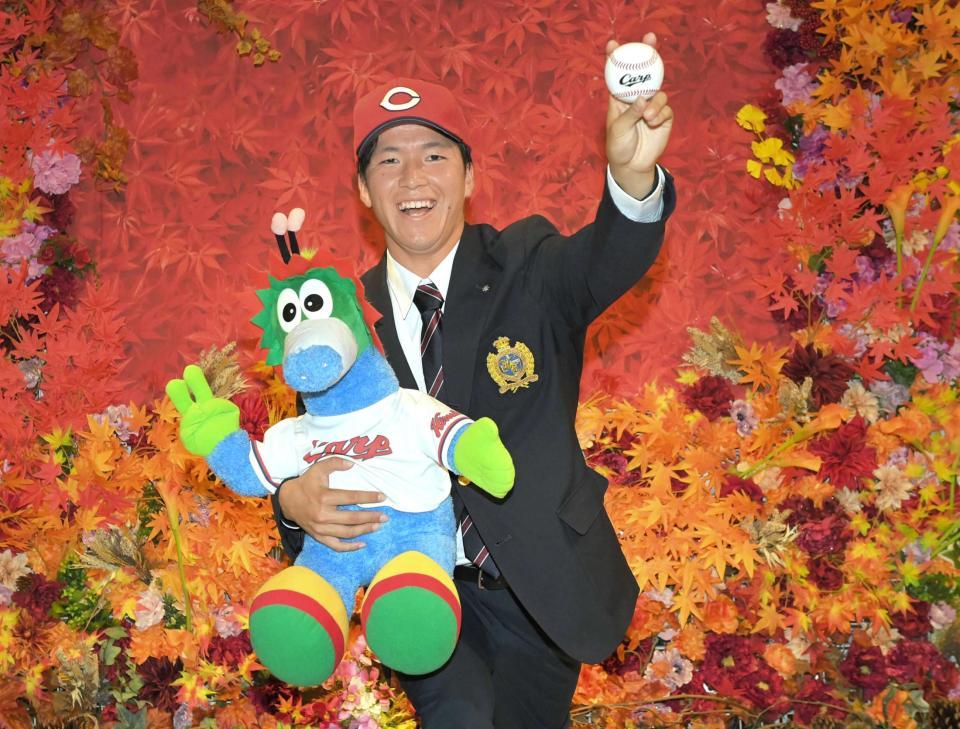 スラィリーを抱き、ピッチングフォームを披露する関学大・黒原（撮影・高部洋祐）