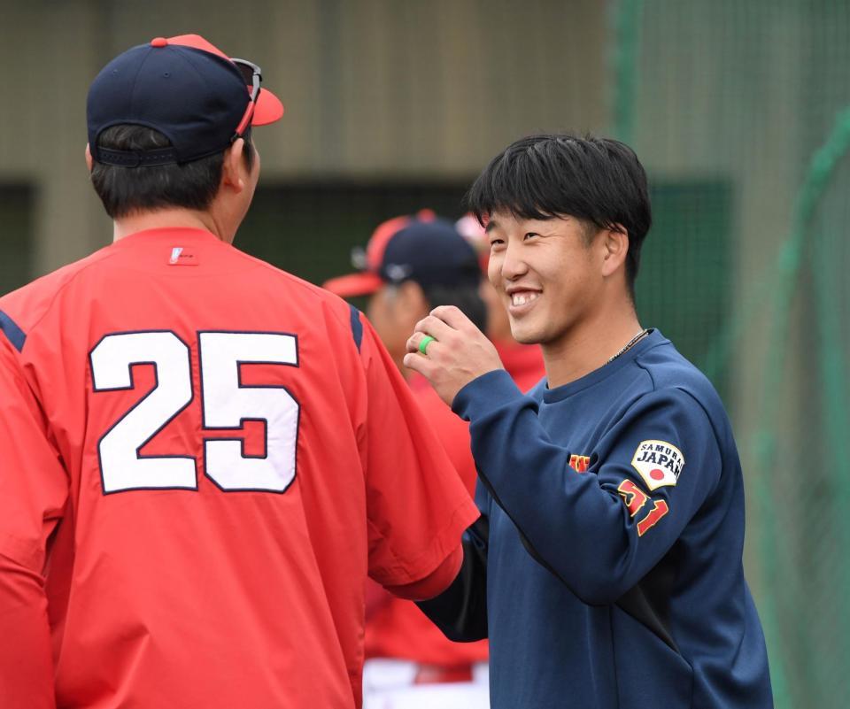 　新井監督（左）にあいさつをする小園（撮影・中田匡峻）