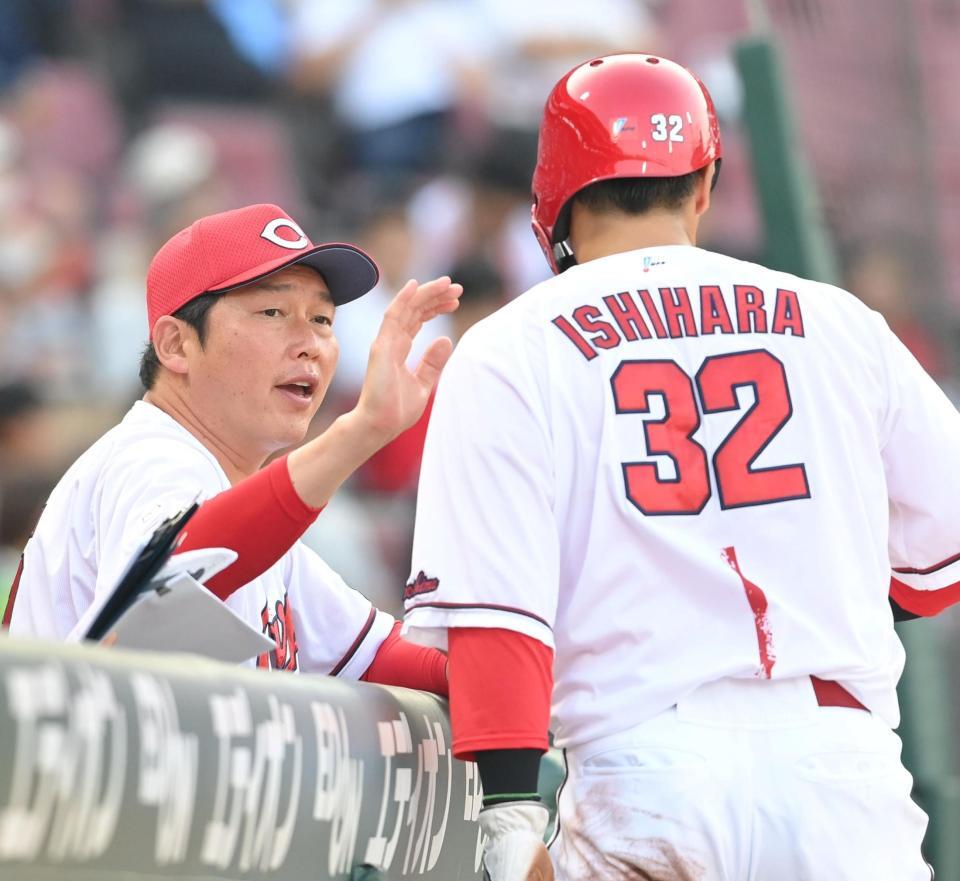 　１回、追加点となる敵失を誘った石原を出迎える新井監督（撮影・市尻達拡）