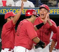 　４回、坂倉の適時打で生還した末包（手前）を迎える新井監督（右）