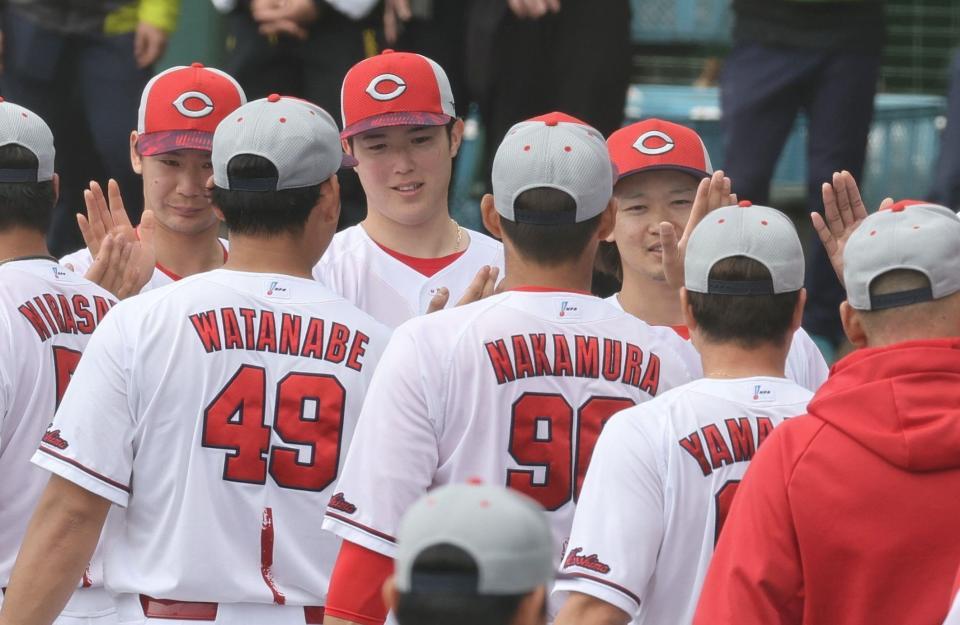 　沖縄でのキャンプを終え、チームメートとタッチを交わす森下（撮影・市尻達拡）