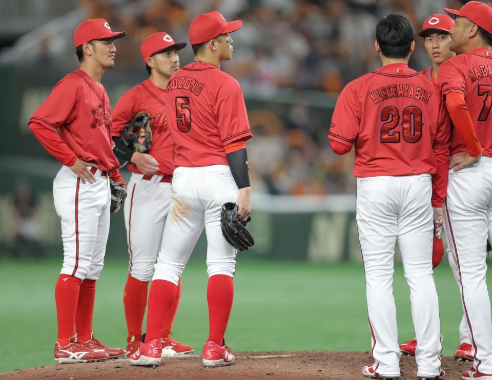 　９回、同点となった後、集まったナインの中で立ち尽くす小園（中央）＝撮影・西岡正