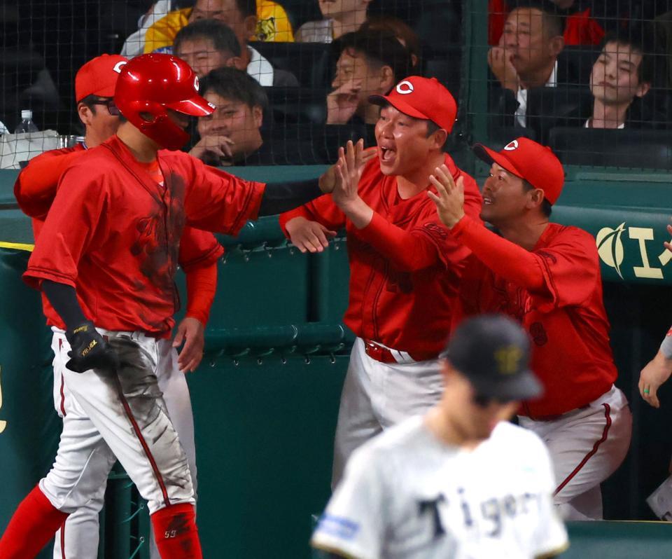 　９回、新井監督（中央右）は生還した大盛を迎える（撮影・山口登）