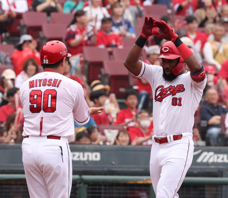 　１回、左越えソロを放ち、三好コーチとタッチをするファビアン（撮影・市尻達拡）