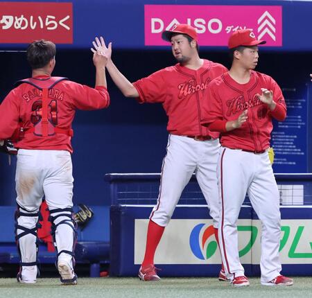 　６回、ピンチをしのぎ、坂倉とタッチを交わす中崎（撮影・市尻達拡）