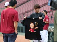　楽天の関係者にチームのオリジナル（？）Ｔシャツを披露する小園＝２１日
