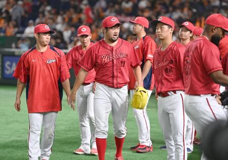 　１０回、丸を遊ゴロに打ち取り出迎えた玉村（６５）らナインを鼓舞する中崎（中央）＝撮影・開出牧