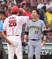 　メンバー表交換時に、言葉を交わす藤川監督と新井監督（撮影・市尻達拡）