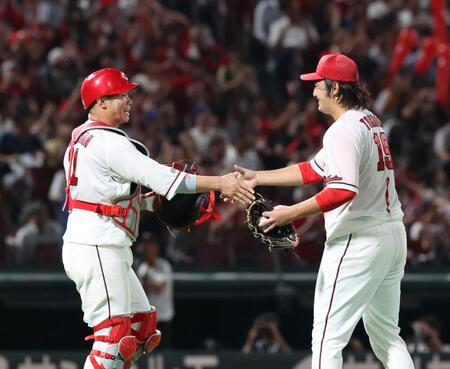 　完投勝利に、坂倉と握手をする床田（撮影・市尻達拡）