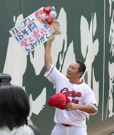 　ファンから感謝の言葉が記されたボードを受け取る松山