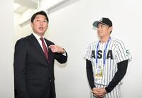　仙台から東京に移動し亜大・斉藤汰直（右）と話す新井監督（撮影・佐藤厚）
