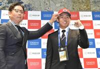 　松本スカウト（左）から帽子をかぶせてもらい、笑顔の中京大・高木