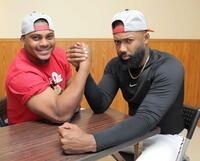 腕相撲で力を込めるモンテロとファビアン（右）＝撮影・北村雅宏