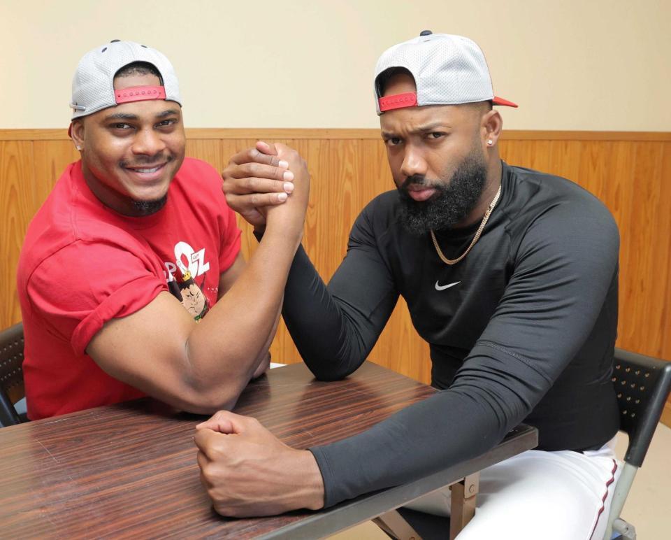 腕相撲で力を込めるモンテロとファビアン（右）＝撮影・北村雅宏