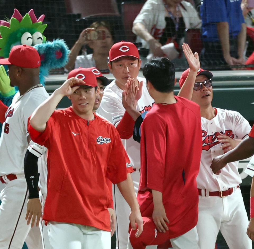 栗林を祝福する新井監督（中央）＝撮影・山口登