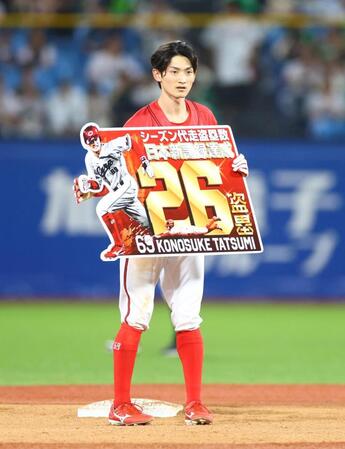 記録達成のパネルを手にする辰見（撮影・石井剣太郎）