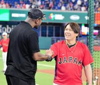 　アダム・ジョーンズ（左）とガッチリ握手する甲斐