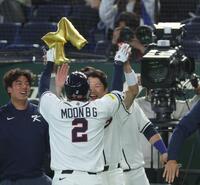 　１回、先制満塁本塁打を放ち金のＭの風船をもらって喜ぶ文保景（撮影・金田祐二）