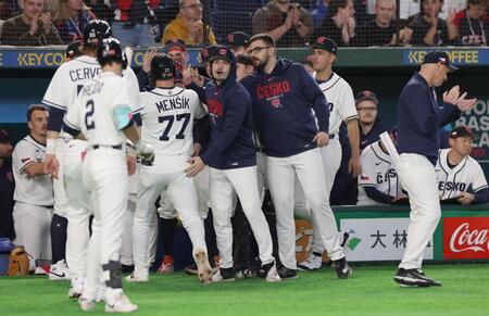 先制の中犠飛を放ったメンシク（７７番）を出迎えるナイン（撮影・佐々木彰尚）