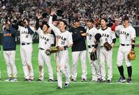 ７日の韓国戦に勝利し、スタンドに向かって笑顔を見せる周東（中央）