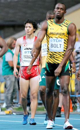 　同組での予選を終えた山県亮太（左）とウサイン・ボルト（共同）