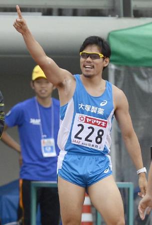 　男子４００メートルで１０連覇を達成し、観客の声援に応える金丸祐三