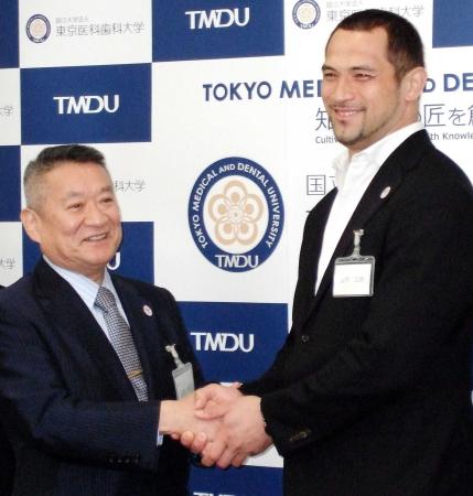 　１０月から東京医科歯科大学の教授に就任する室伏広治（右）は吉澤靖之学長と握手をかわす