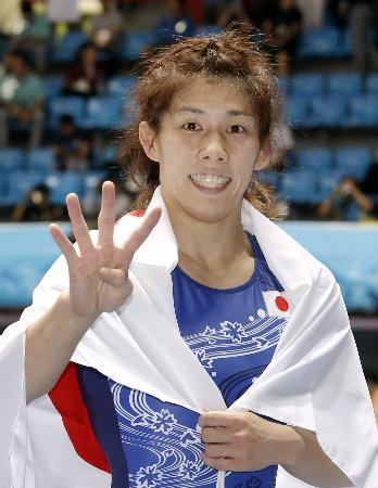 　女子５５キロ級で優勝し、４連覇を指で示す吉田沙保里＝仁川（共同）